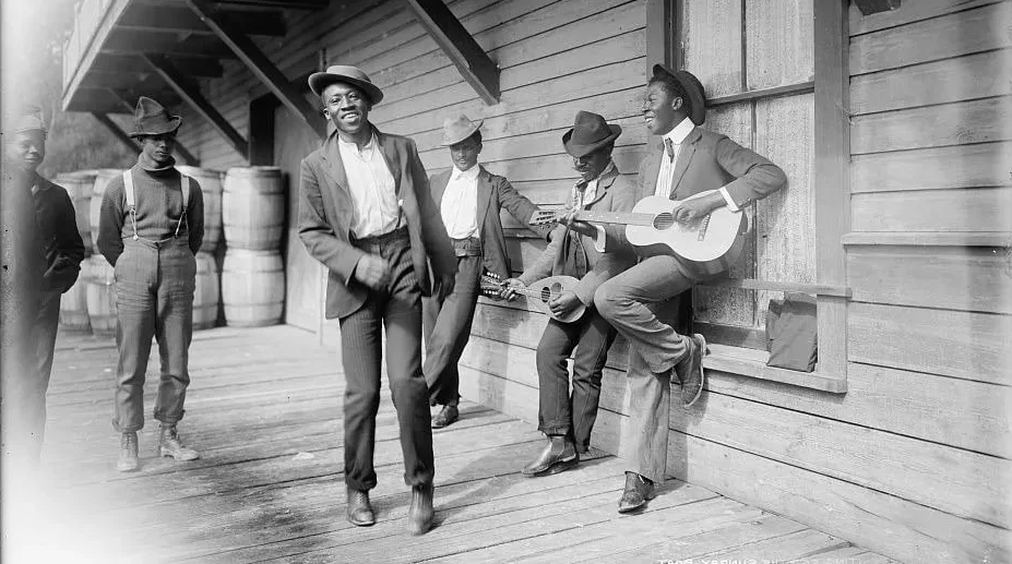 black american musicians playing side of building